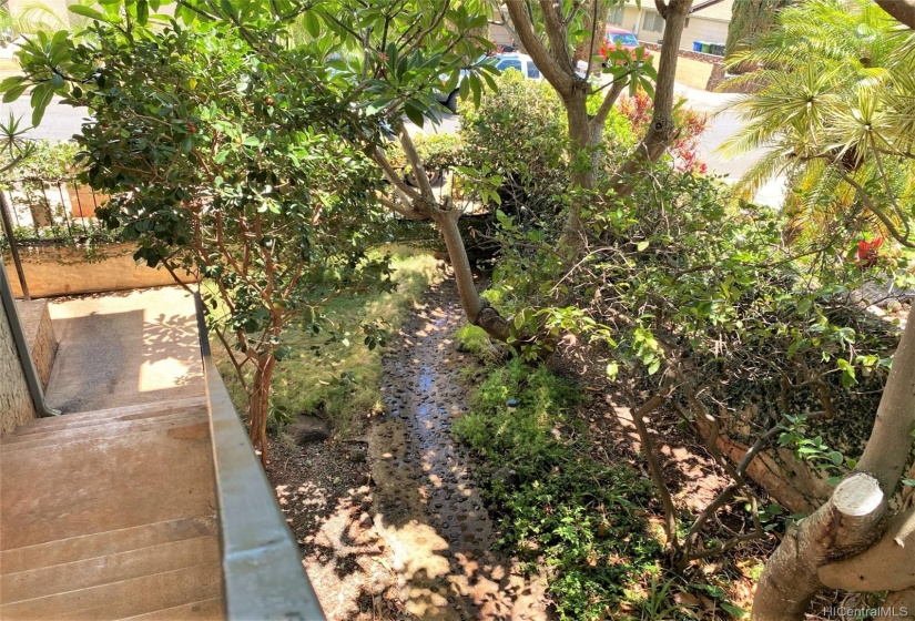 Landscaping in front includes stream drain for upper level.