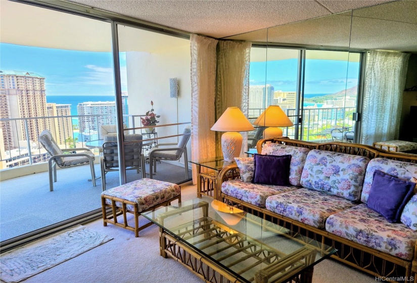 Living room looking to lanai with Diamond Head and ocean views reflecting in the mirrrors