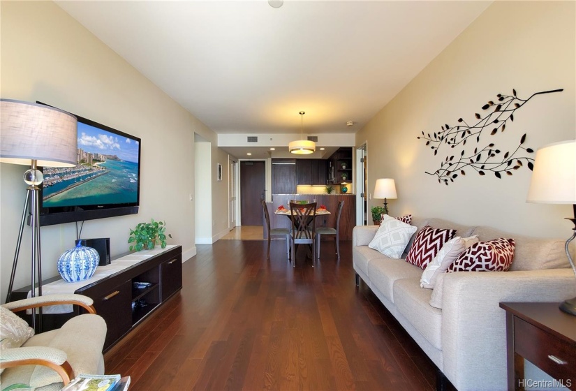 Spacious living room. Looking at the entrance door and Kitchen/Dining area from Lanai through Living room. Right door goes to Master Bedroom and Master Bath. Left hallway to the second bedroom and guest bath.