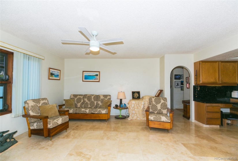 the family room off the kitchen - with travertine floors and big enough for an entertainment area or an office or a room to gather for fun and enjoyment!  Oh look, another archway!