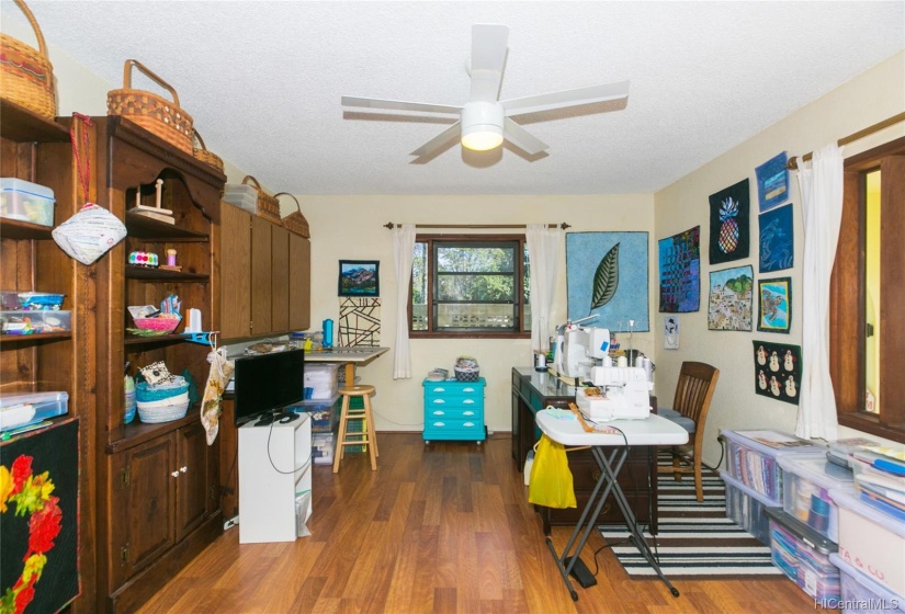 This is the large ground floor bedroom with laminate floors and some built in cabinets and windows for cool breezes and light!