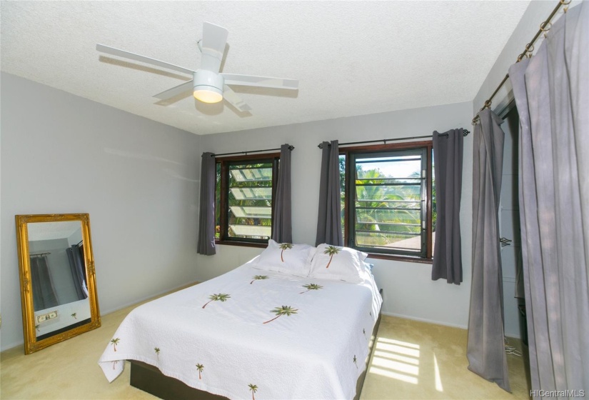 2nd bedroom upstairs with awning windows and fan with light.  The 