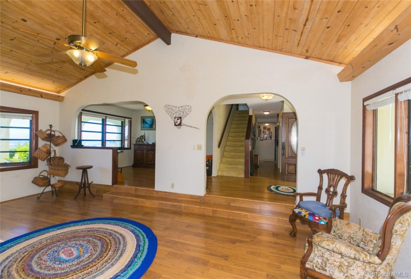 This view shows the stairs to the second floor.  the covered lanai looking out t the view is through the windows on the left.