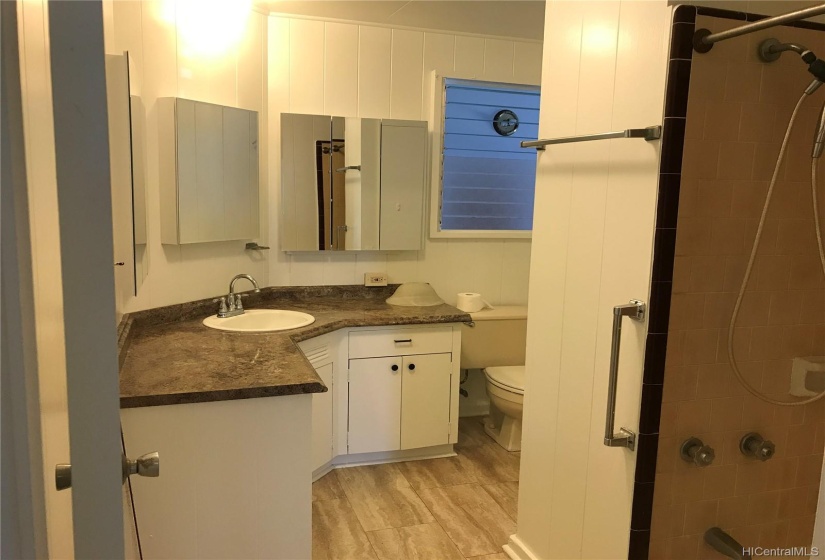 Larger bathroom in the hallway between 2 bedrooms.  Has tub and shower stall. The second bathroom is attached to master bedroom.