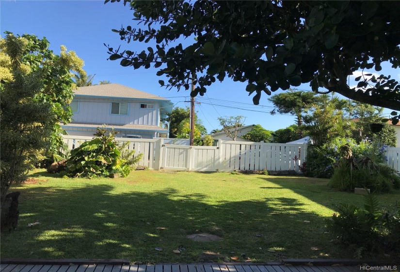 View from your deck into yard.  Fence/gate goes out onto Crozier Loop, where you can access the property'sprivate deeded beach access.