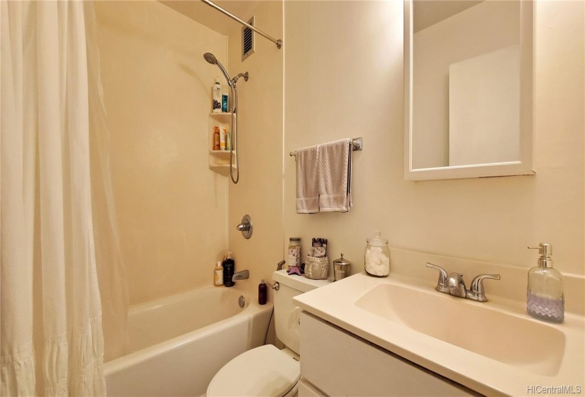 Main bathroom with shower over tub