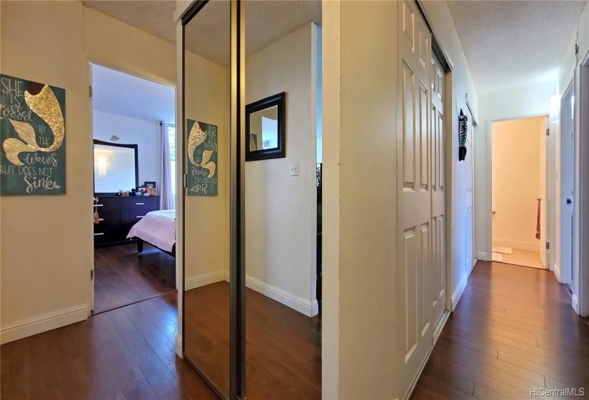 Hallway looking to the main bedroom and bathroom to the left. The hallway has lots of storage w/ 3 closets. On the right are the other 2 bedrooms and the half bath at the end of the hall.