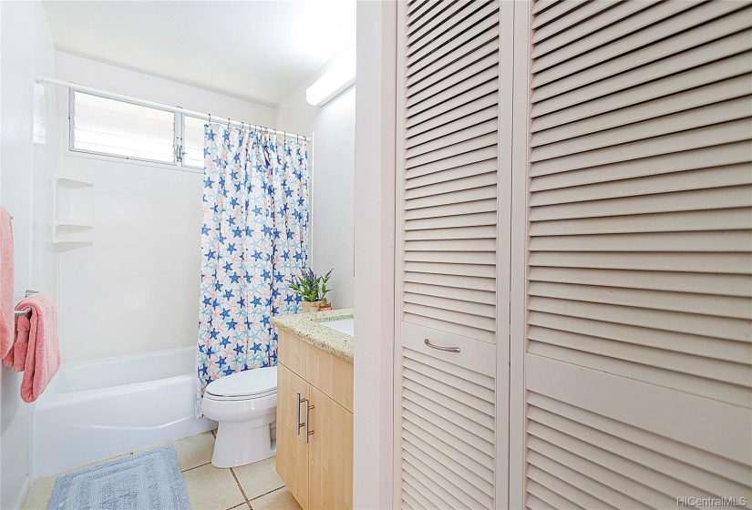 Updated hall bathroom with large linen closet.