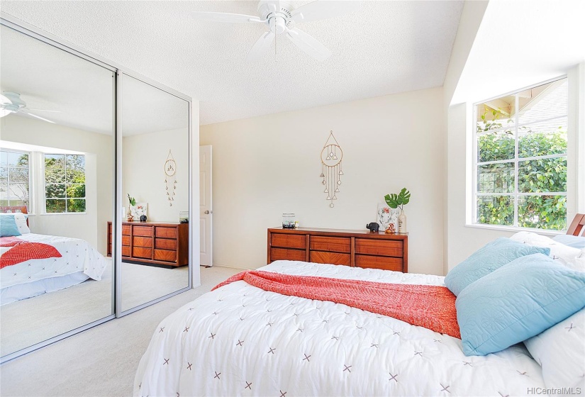 Floor to ceiling closet with mirrored doors with lots of storage space.