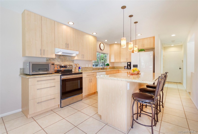 Updated kitchen with recessed lighting & granite countertops.