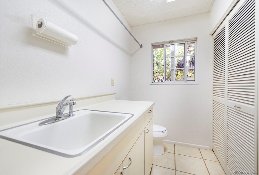 Laundry room and half bath is between the garage and kitchen area.