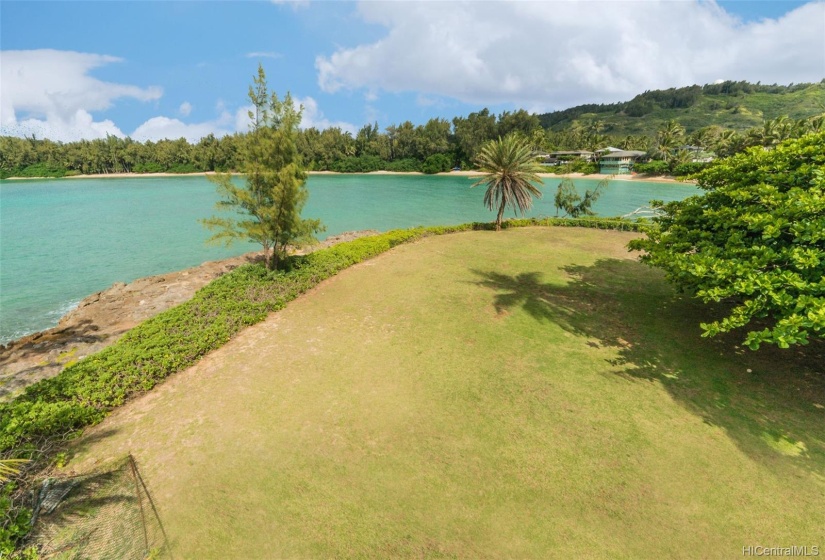 Kawela Bay is a private, gated community. The lot is spacious at 23,522 square feet with over 200 feet of ocean frontage. There is a small sandy cove that adjoins this property that leads to the main beach shown here in the distance.