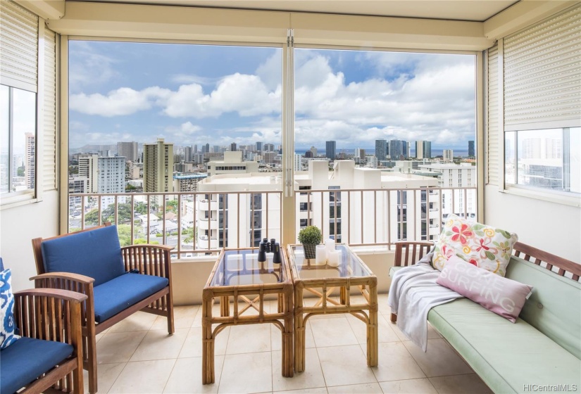 Fabulous lanai with hurricane shutters and stunning city and ocean views. Nice and breezy with lots of breeze.  Perfect place to welcome the day or end the night.