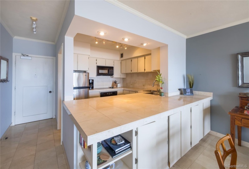 Tons of storage under the large island that divides the kitchen from the living area.