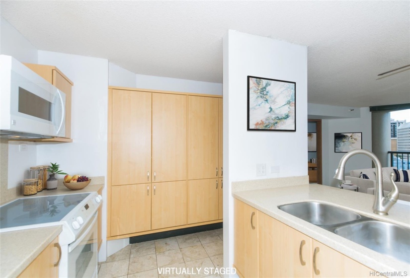 Solid surface counter tops, ceramic stove top, combination micro/convection oven and a wall of additional cabinets. Counter is also a breakfast bar.