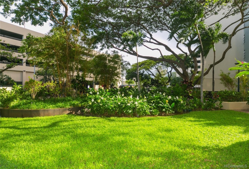 Pretty landscaped grounds and mature trees of the secured complex grounds.