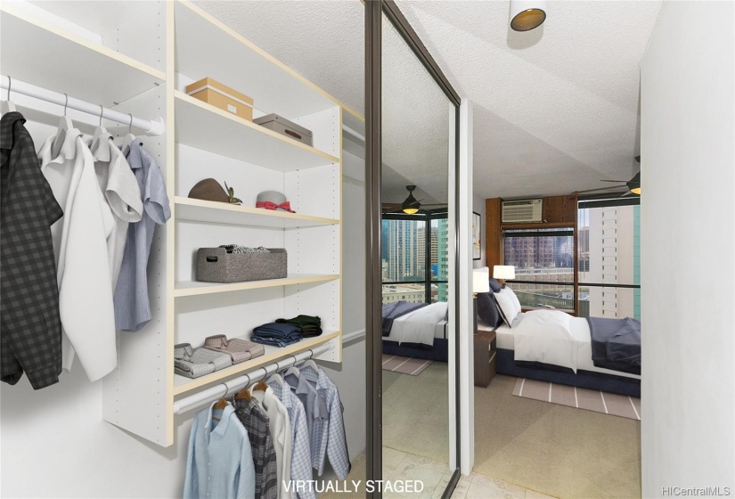 Large closet with built-ins and mirrored doors is part of the primary bedroom.