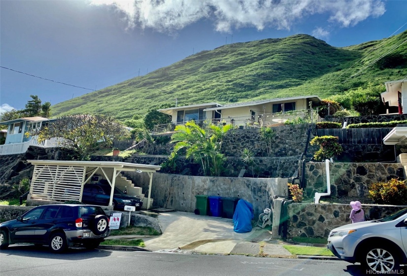 View of home from across the street; carport and steps