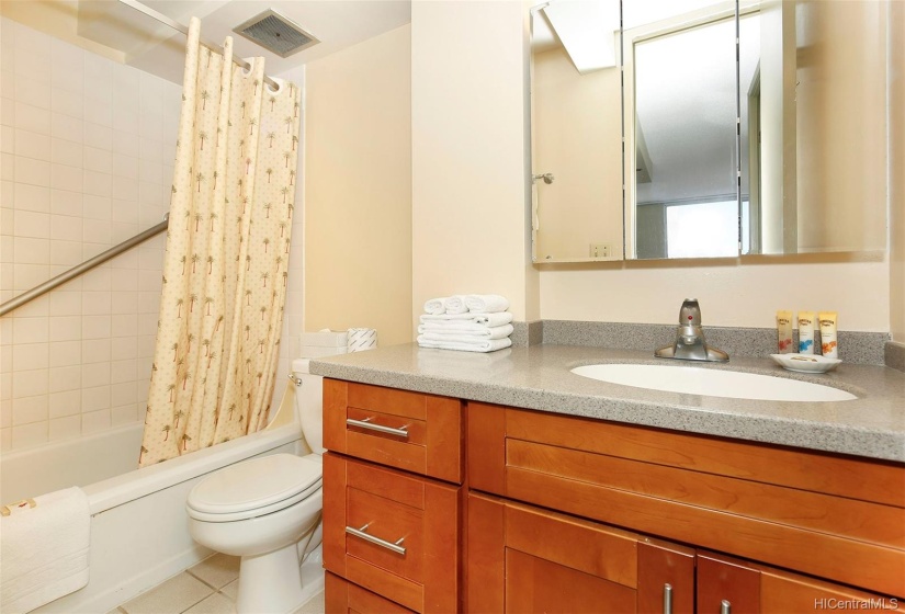 Neat and bright bathroom with a tub.