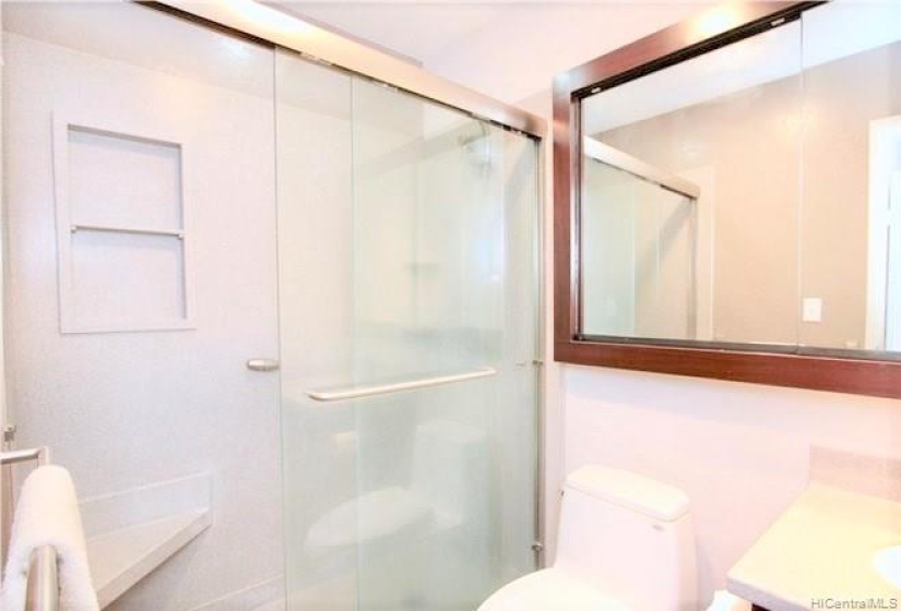 Primary bedroom's en-suite bathroom (huge medicine cabinet storage behind the mirror)