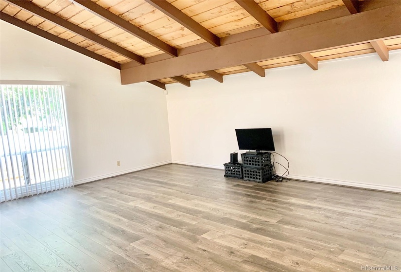 Large living room with vaulted, beamed ceilings