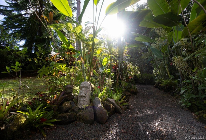 Extensive landscaping, walk ways to wind and meditate.  Lush garden with fruit trees, tea, coffee and Hawaiian foliage.