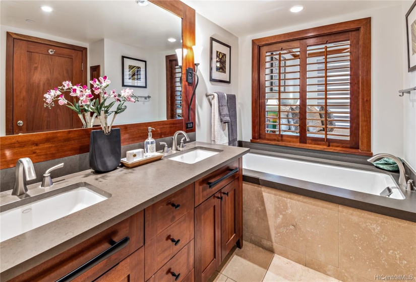 Master bathroom with dual sinks and large soaking tub