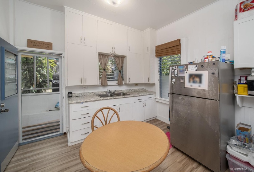 Newer luxury vinyl plank flooring in the kitchen with upgraded countertops