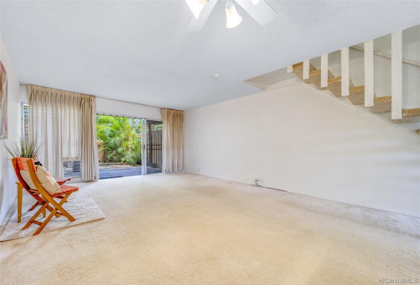 living area with kitchen nearby, flows into spacious outdoor space