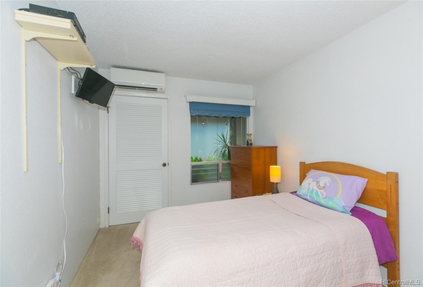 Another view of Master bedroom showing window and door to outside space at front.