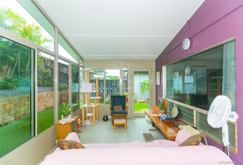 Spacious Sunroom with vinyl flooring and tinted window.