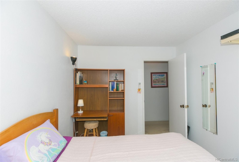 Guest bedroom with large window.