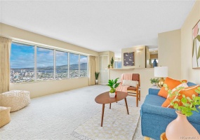 Spacious living room with ocean, city and mountain views.