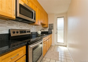 Upgraded kitchen with cherry cabinets, granite counters, designer back splash and stainless steel appliances.