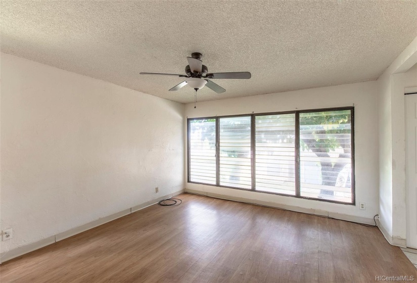 Living room with lots of natural light with floor to ceiling windows!