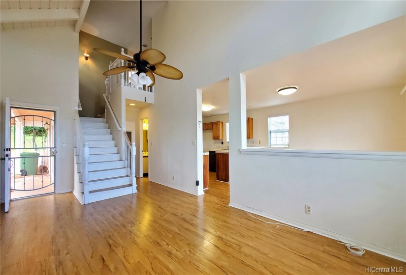 Interior Living area looking at front entry and on the right of stairway is half bath. Stairway leading to 2nd floor 3 bedrooms and 2 bathrooms