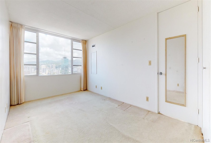 Large bedroom with AC and great city and mountain views.  Needs new flooring and reflected in pricing.