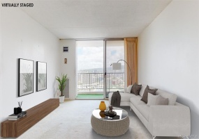 Virtually staged photo.  Large living room with central AC and lanai.  Lanai view includes city, mountain, canal, Ala Moana Beach Park, and ocean.