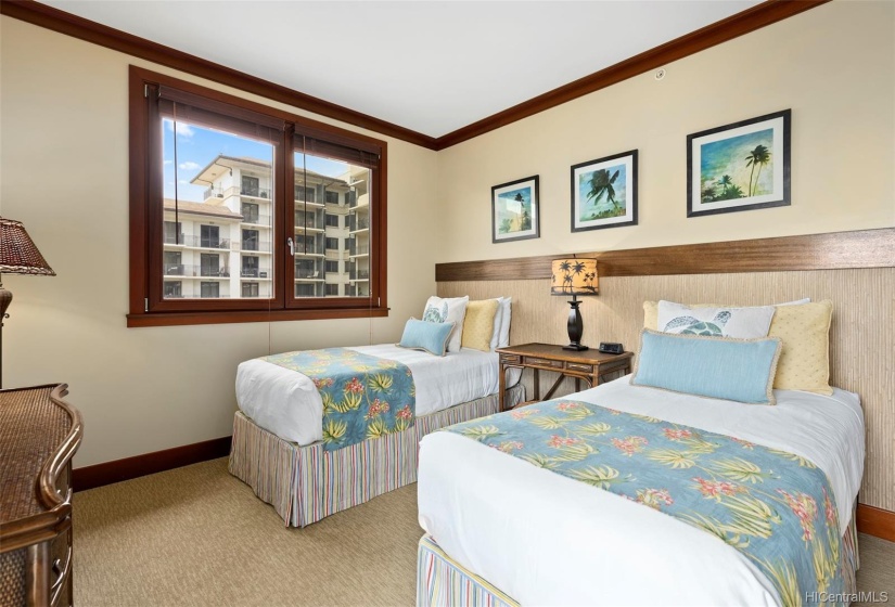 Guest bedroom with two twin beds that can be converted to a king; ocean views w/ private balcony lanai access.