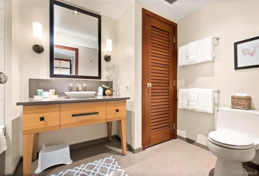 Guest bathroom with linen closet, deep soaking tub/shower combo.