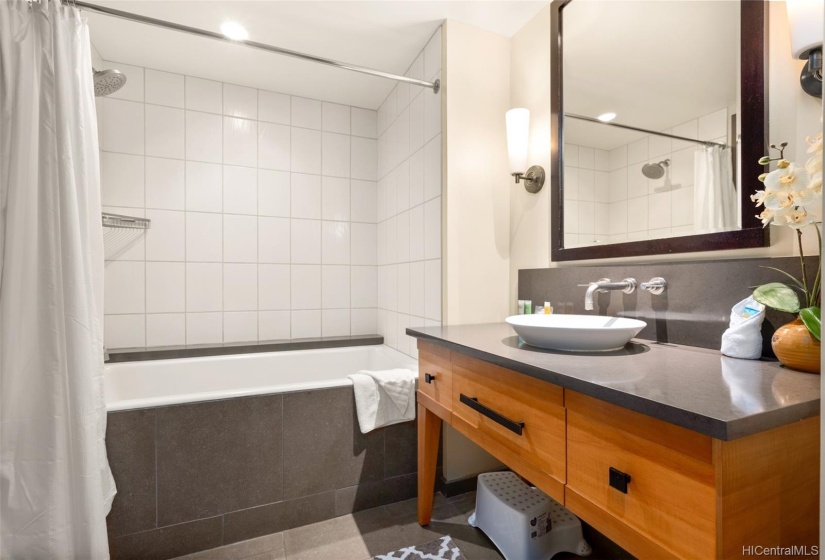 Guest bathroom with linen closet, deep soaking tub/shower combo.