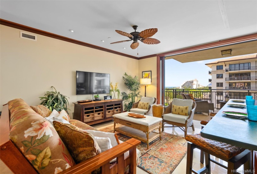 Living area adjacent pocket lanai doors. New chairs and barstools.