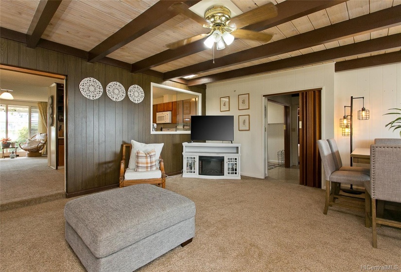 The family room is next to the kitchen with a pass through window. The opening on the right leads to a laundry area and a second master bedroom.