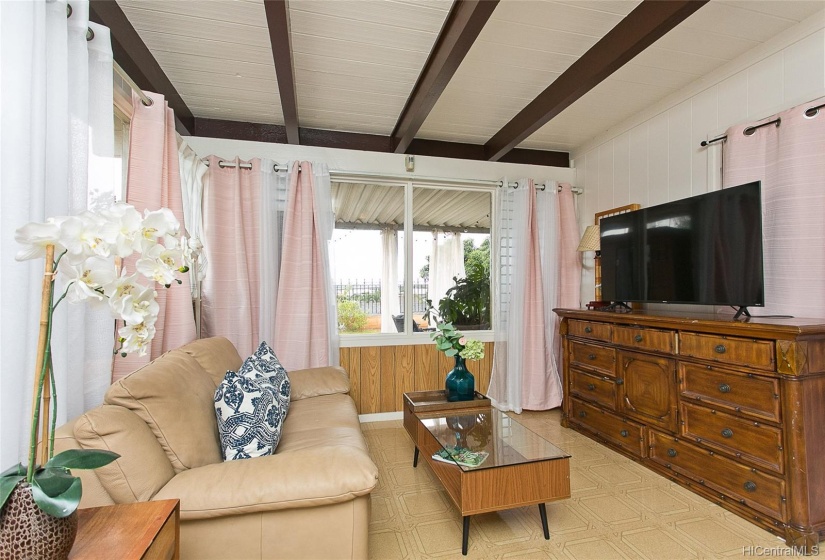 The second master bedroom is filled with natural light and is large enough for a sofa. A new 10,000 BTU AC was installed. A security door opens to a side yard.