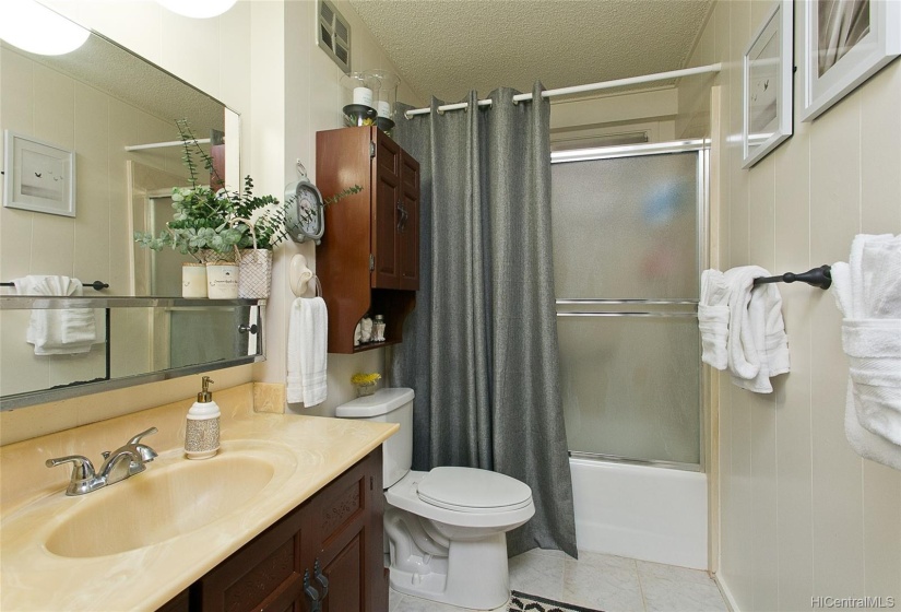 Sparkling clean bathroom with tub.