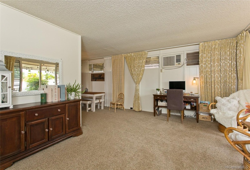 The living room has new carpets and a new 24,000 BTU GE AC. Three bedrooms and 1.5 bathrooms are down a hallway on the left.