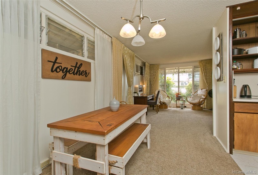 An informal dining area is outside of the kitchen. It is between the living room and family room.