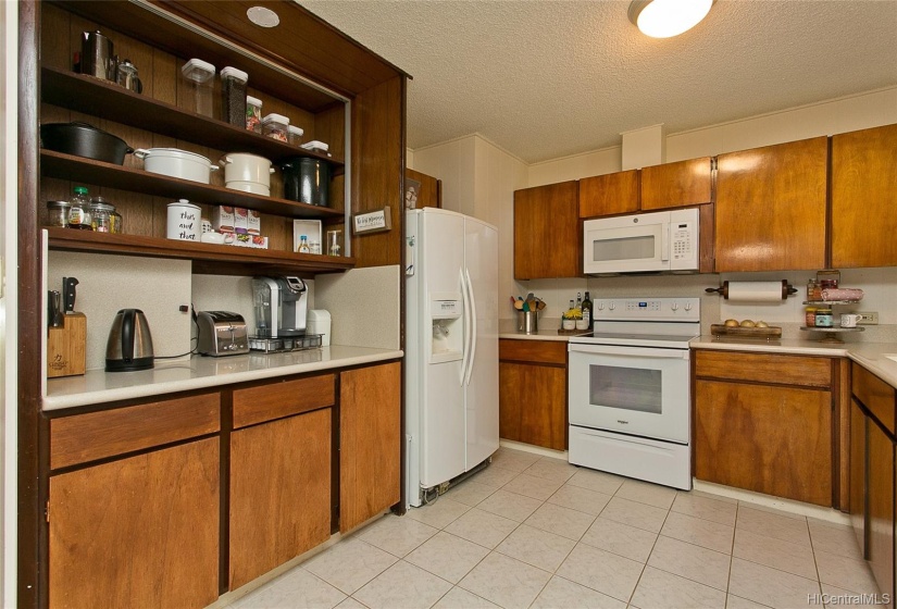 This immaculate kitchen has ample solid wood cabinets and corian countertop space to prepare your culinary creations.