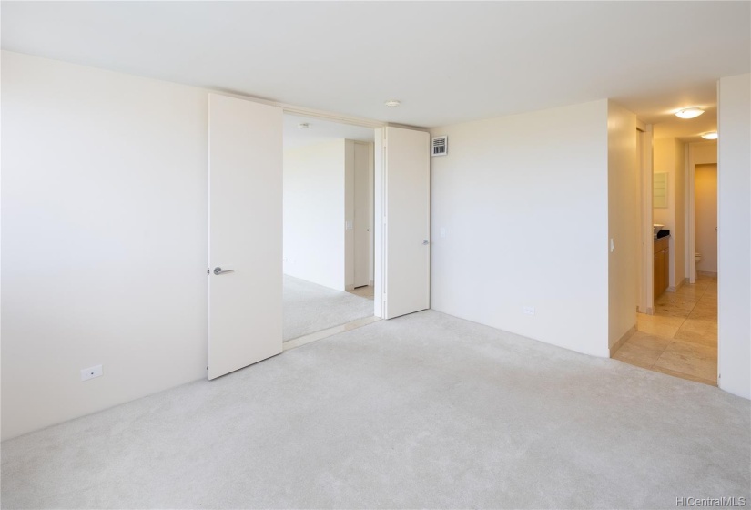 The master bedroom offers double door entry and the master bath