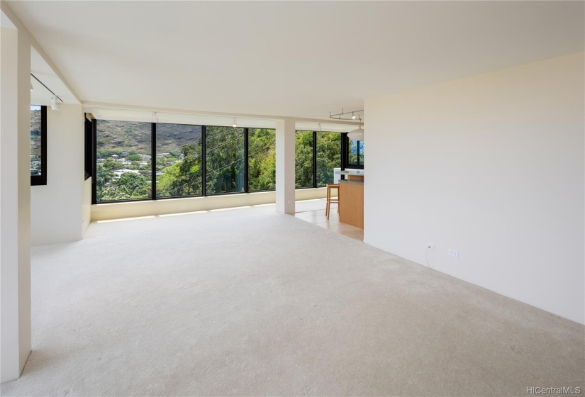 Around the corner in this photo is a dining area and the kitchen.